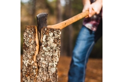 A man chopping a chunk of wood.